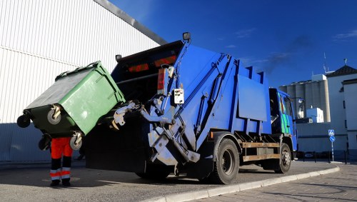 Van and crew preparing office clearance in Soho with recycling bins